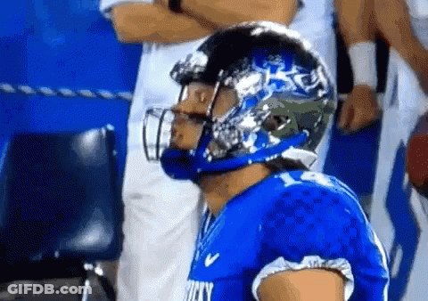 A Football Player Wearing A Helmet That Says Rocky GIF