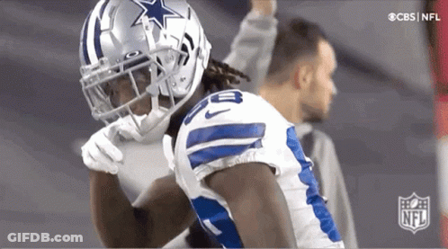 A Football Player Wearing A Helmet With A Star On It Is Standing In Front Of A Cbs Nfl Logo GIF