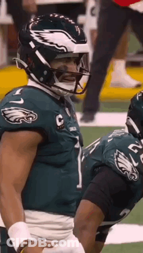 A Football Player Wearing A Helmet With An Eagle On It GIF