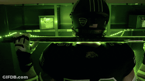 A Football Player Wearing A Helmet With Bleed On It GIF