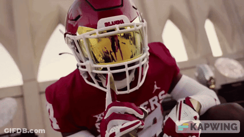 A Football Player Wearing A Helmet With Oklahoma Written On It GIF