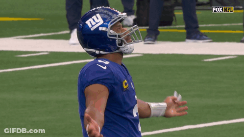 A Football Player Wearing A Helmet With The Letter Ny On It GIF