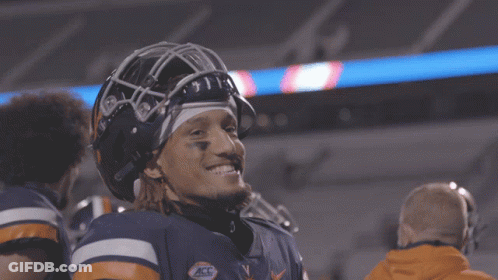 A Football Player Wearing A Helmet With The Letters V On It GIF