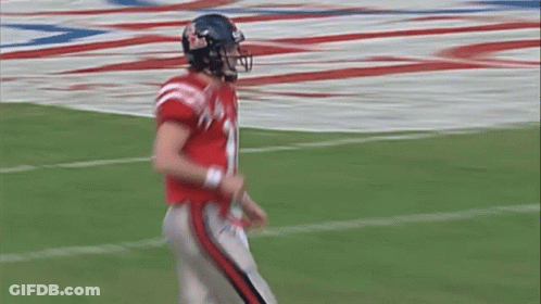 A Football Player Wearing A Helmet With The Number 10 On It GIF