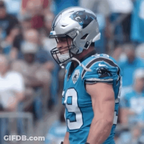 A Football Player Wearing A Helmet With The Number 9 On His Jersey GIF