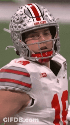 A Football Player Wearing A Helmet With The Word Ohio State On It GIF