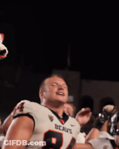 A Football Player Wearing A Jersey That Says Beavs Stands In Front Of A Crowd GIF