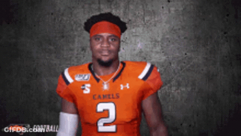 A Football Player Wearing A Jersey That Says Camels On It GIF