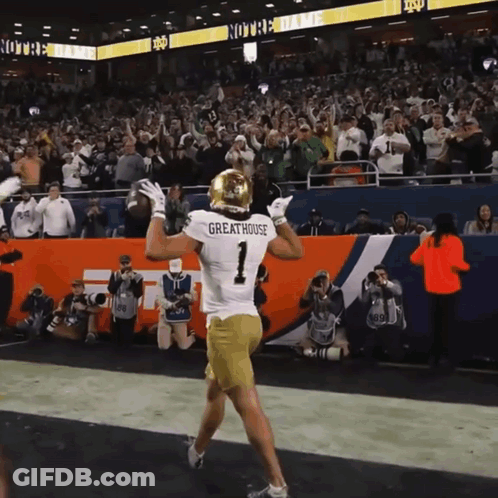 A Football Player Wearing A Jersey That Says Greathouse GIF