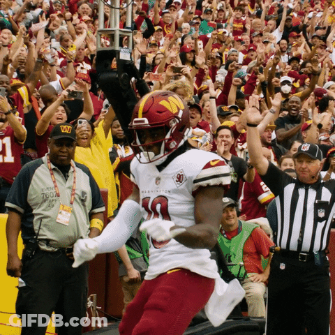 A Football Player Wearing A Jersey That Says Washington GIF