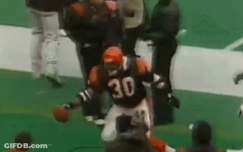 A Football Player Wearing A Jersey With The Number 30 On It Is Running On The Field . GIF
