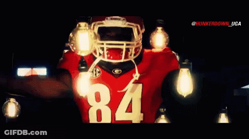 A Football Player Wearing A Jersey With The Number 84 On It GIF