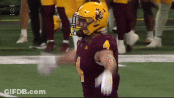 A Football Player Wearing A Maroon Jersey And A Yellow Helmet With The Number 4 On It GIF