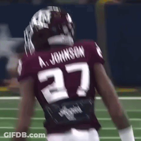 A Football Player Wearing A Maroon Jersey With The Number 27 On It . GIF