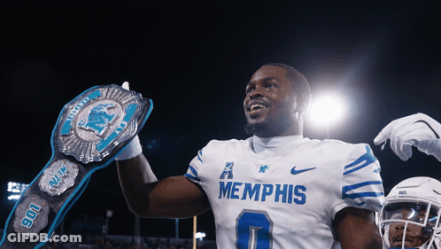 A Football Player Wearing A Memphis Jersey Holds A Championship Belt GIF