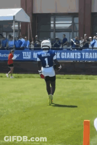 A Football Player Wearing A Number 1 Jersey Is Running On The Field GIF