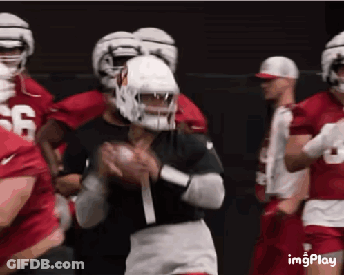 A Football Player Wearing A Number 1 Jersey Is Throwing The Ball GIF