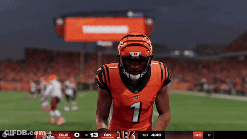A Football Player Wearing A Number 1 Jersey Stands On A Field GIF