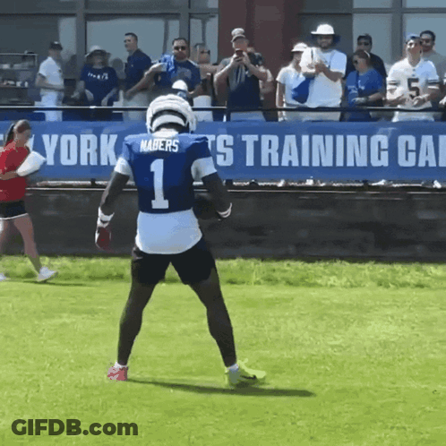 A Football Player Wearing A Number 1 Jersey Stands On The Field GIF