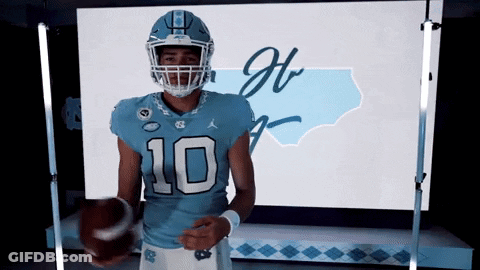 A Football Player Wearing A Number 10 Jersey Holds A Football GIF