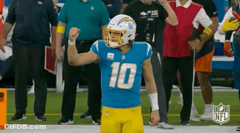 A Football Player Wearing A Number 10 Jersey Is Standing On A Field . GIF