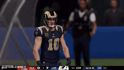 A Football Player Wearing A Number 10 Jersey Stands On A Field GIF