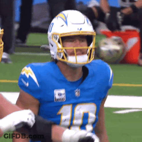 A Football Player Wearing A Number 10 Jersey Stands On The Field GIF
