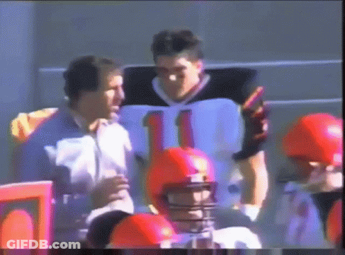 A Football Player Wearing A Number 11 Jersey Talks To Another Player GIF