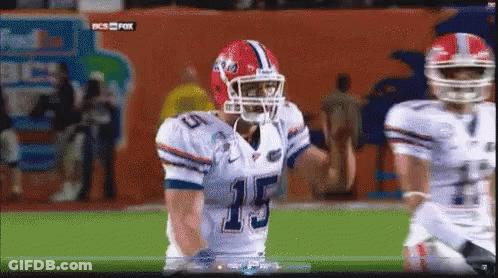 A Football Player Wearing A Number 15 Jersey Stands On The Field GIF