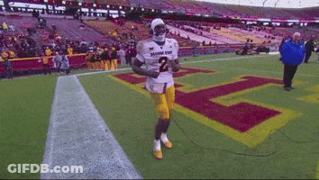 A Football Player Wearing A Number 2 Jersey Is Running On The Field GIF