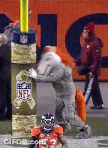 A Football Player Wearing A Number 32 Jersey Is Being Tackled By A Mascot From The Nfl GIF