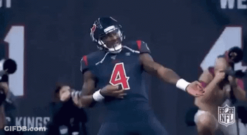 A Football Player Wearing A Number 4 Jersey Is Dancing On A Field . GIF