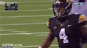 A Football Player Wearing A Number 4 Jersey Is Running On The Field GIF
