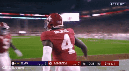 A Football Player Wearing A Number 4 Jersey Is Running On The Field GIF