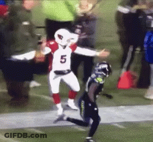 A Football Player Wearing A Number 5 Jersey Is Running On A Field . GIF
