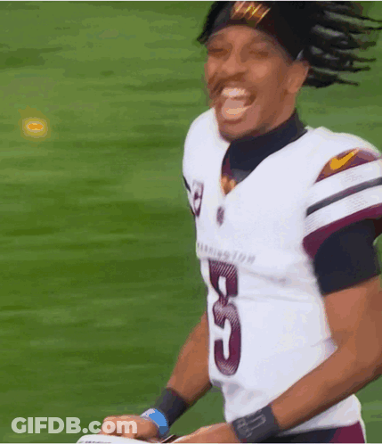 A Football Player Wearing A Number 5 Jersey Is Smiling GIF