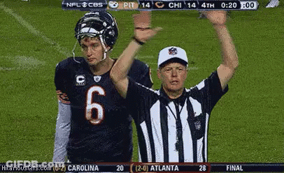 A Football Player Wearing A Number 6 Jersey Stands Next To A Referee . GIF