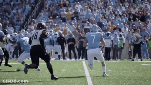 A Football Player Wearing A Number 7 Jersey Is Running On The Field GIF