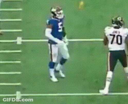 A Football Player Wearing A Number 70 Jersey Stands On The Field GIF