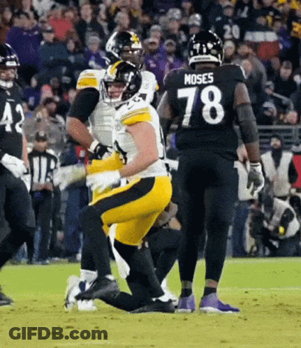 A Football Player Wearing A Number 78 Jersey Is Kneeling On The Field . GIF