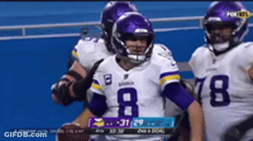 A Football Player Wearing A Number 8 Jersey Holds A Football GIF