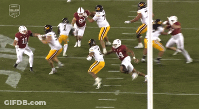 A Football Player Wearing A Number 8 Jersey Is Surrounded By Other Players GIF