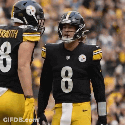 A Football Player Wearing A Number 8 Jersey Talks To Another Player GIF