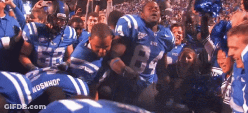 A Football Player Wearing A Number 84 Jersey Is Surrounded By Other Players GIF
