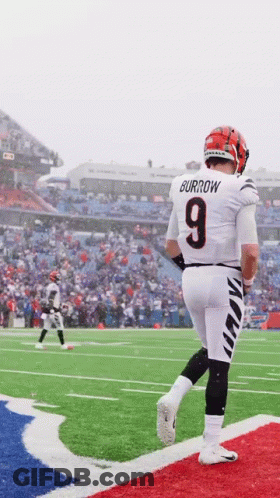 A Football Player Wearing A Number 9 Jersey Is Walking On The Field GIF