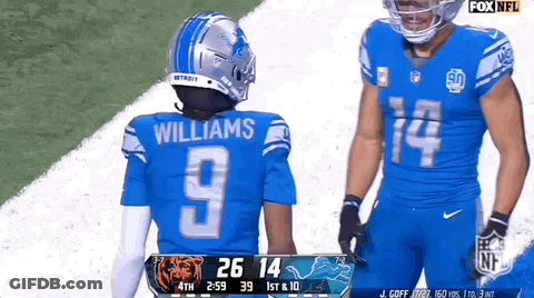 A Football Player Wearing A Number 9 Jersey Stands Next To A Player Wearing A Number 14 Jersey GIF