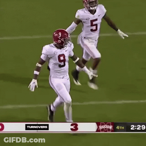 A Football Player Wearing A Number 9 Jersey Stands Next To A Player Wearing A Number 5 Jersey . GIF