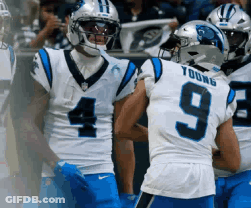 A Football Player Wearing A Number 9 Jersey Talks To Another Player GIF