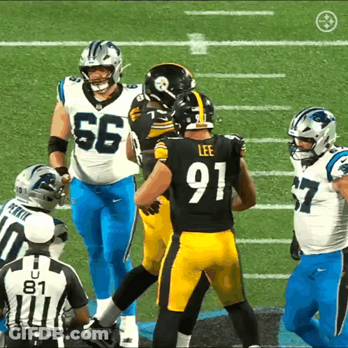 A Football Player Wearing A Number 91 Jersey Talks To Another Player GIF