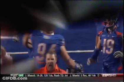A Football Player Wearing A Number 94 Jersey Talks To Another Player GIF